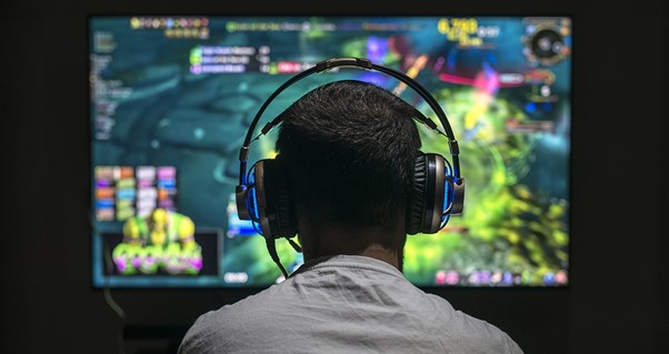 a guy with his headphones on while playing a game
