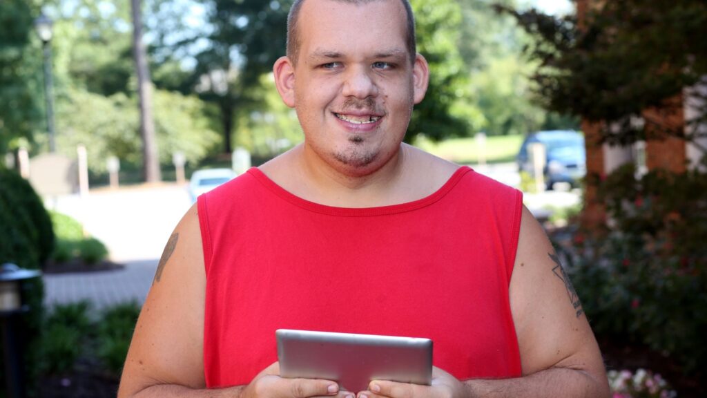 A guy holding a tablet