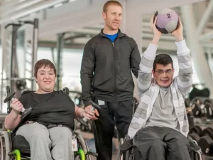 Two young people living with disability exercising to improve their health and wellbeing.